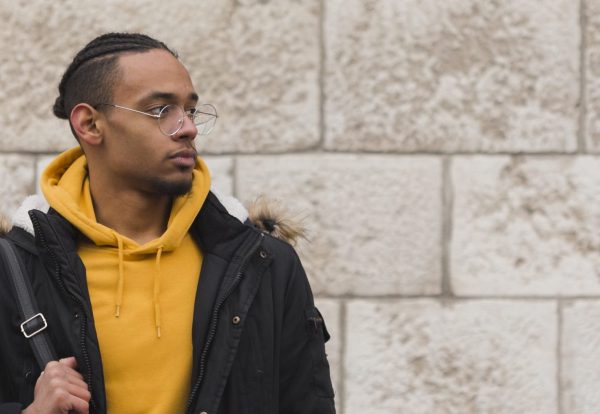 medium-shot-guy-holding-his-yellow-backpack